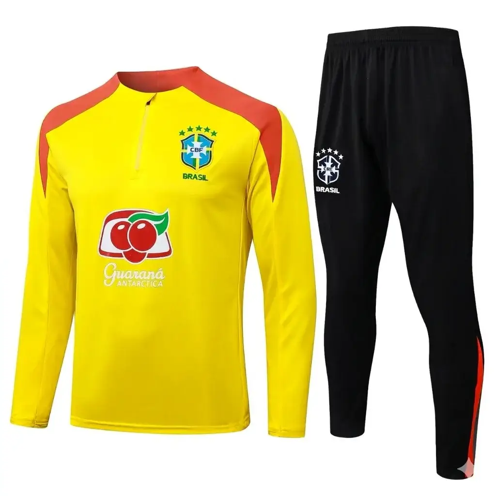 Unbranded (no Nike Swoosh) Brazil national team yellow quarter-zip long-sleeved training kit top with black pants set. Detailed CBF Brazil crest with stars and 'BRASIL' text on left chest and right thigh. Prominent Guaraná Antarctic sponsor logo in center of top. Quarter-zip collar, red-orange accent, and orange details on lower pants. Set is clean without any Nike branding marks, ready for a wholesale page display.